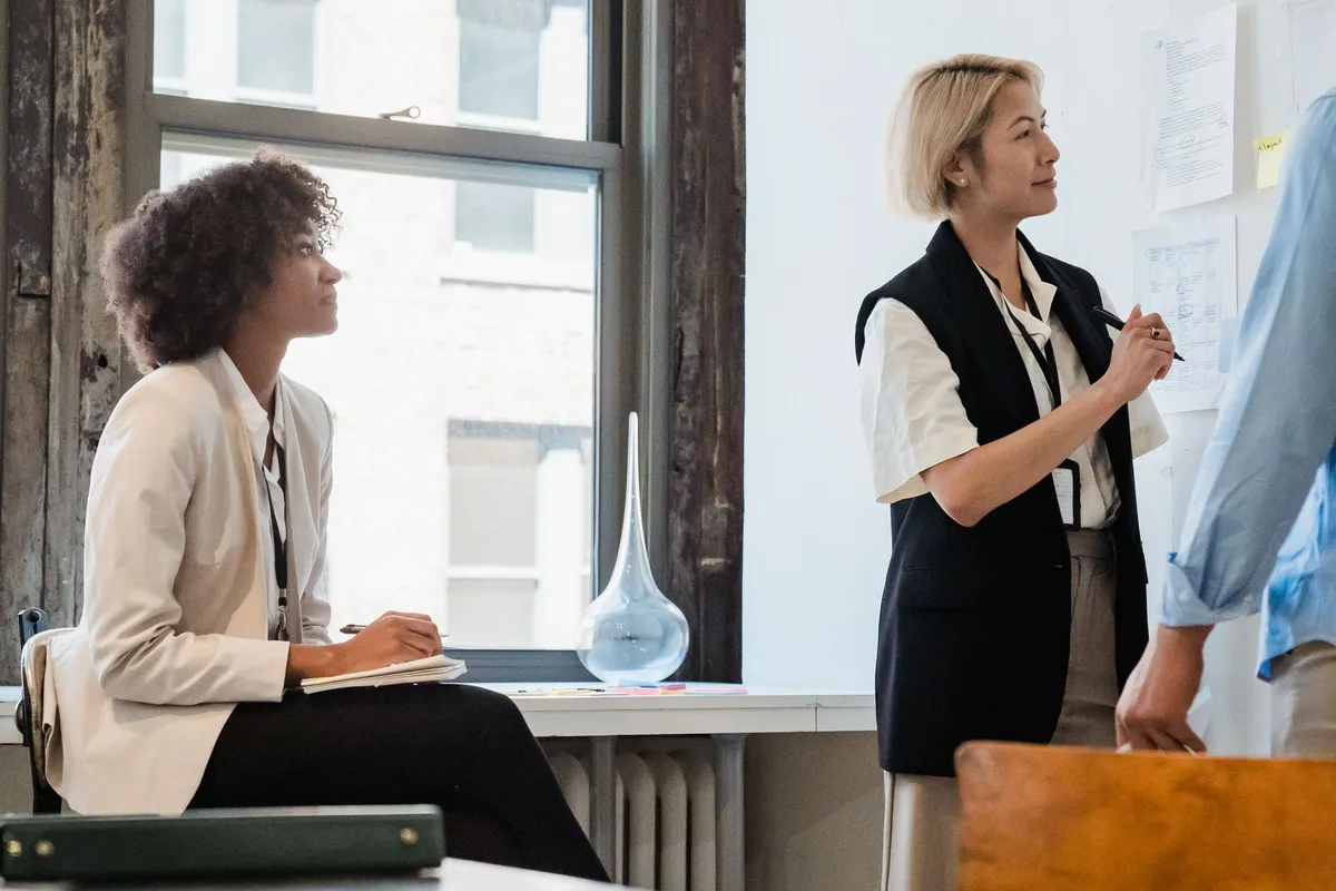 Two colleagues going through documents in an office